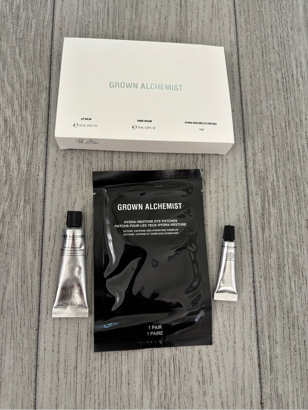 Grown Alchemist travel mini trio lip balm hand cream eye patches. New and sealed